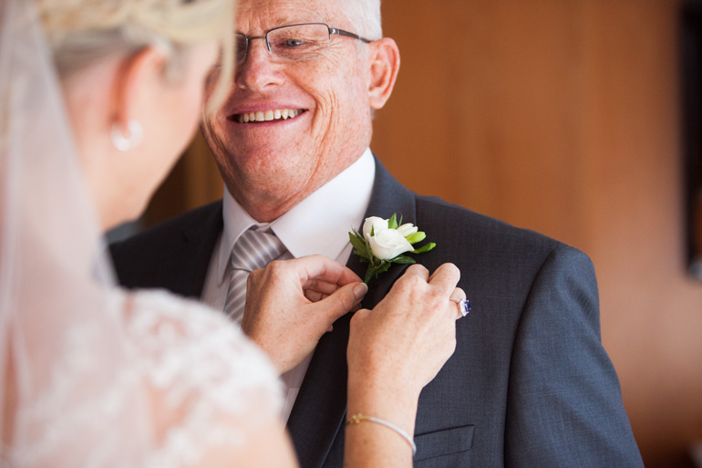 Bride Pinning a Boutonniere